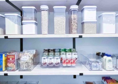 Well organized pantry using plastic and acrylic organizers